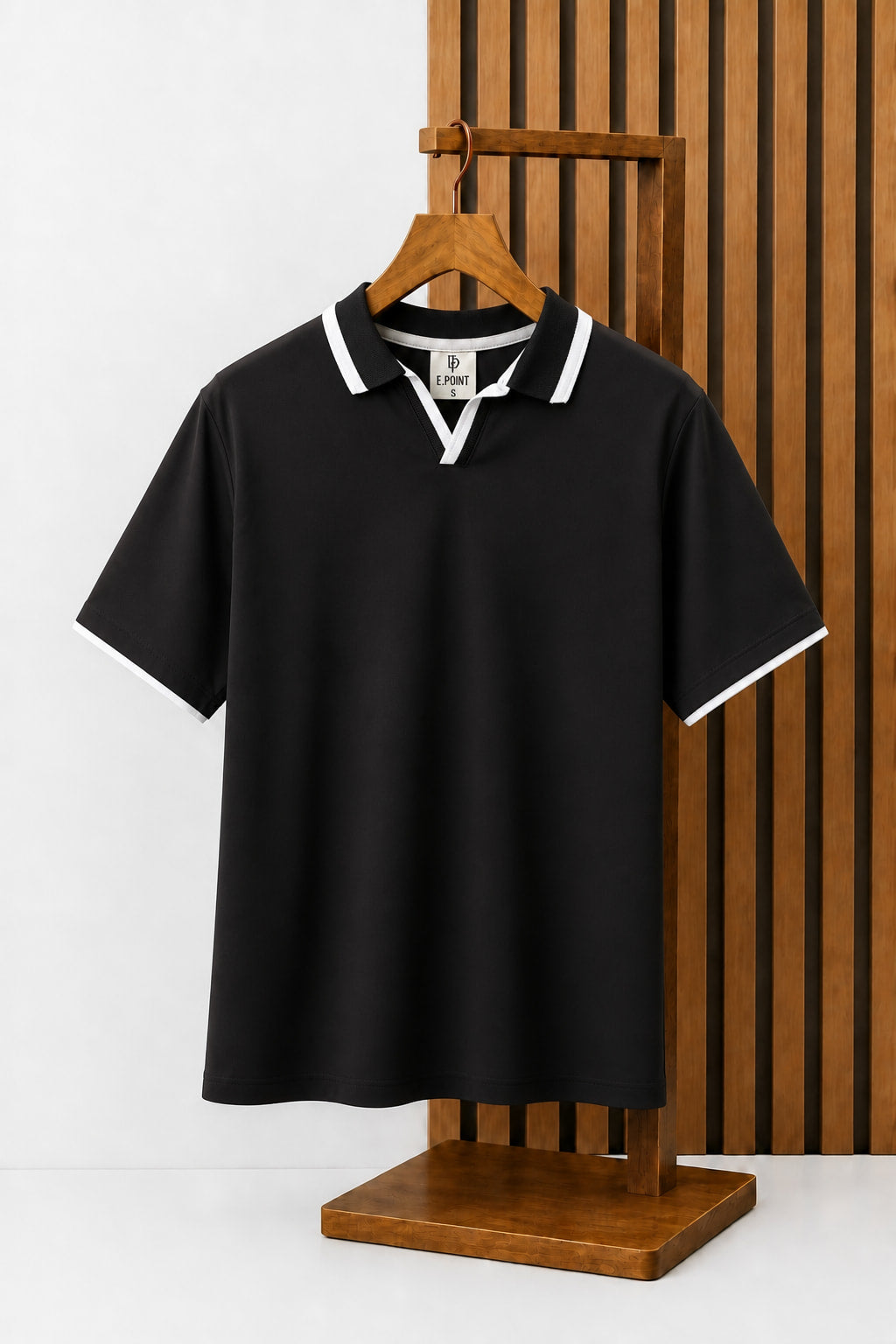Open-Collar Piqué Polo in Black with contrast tipping, on a wooden hanger