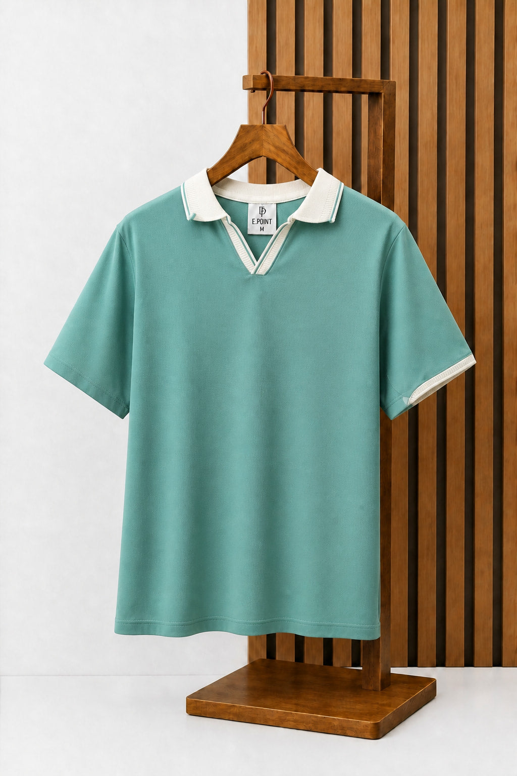 Open-Collar Piqué Polo in Sage with contrast tipping, on a wooden hanger